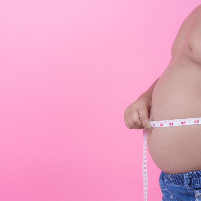obese-boy-who-is-overweight-pink-background